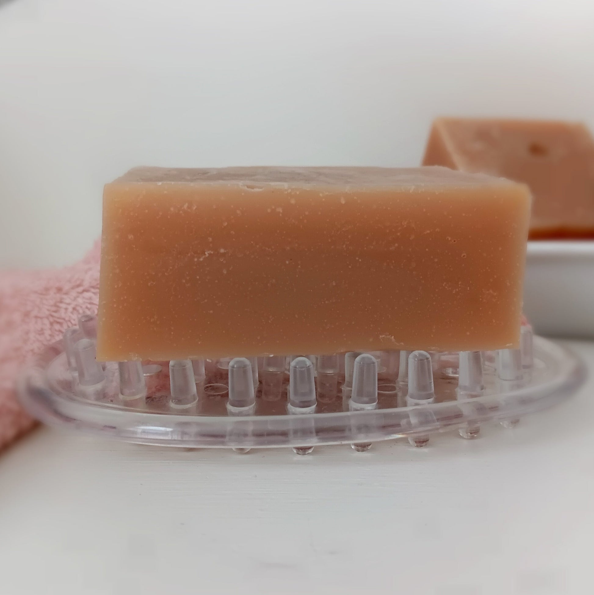 Bar of soap from The Straddle Creek Soap Shop on a clear soap dish