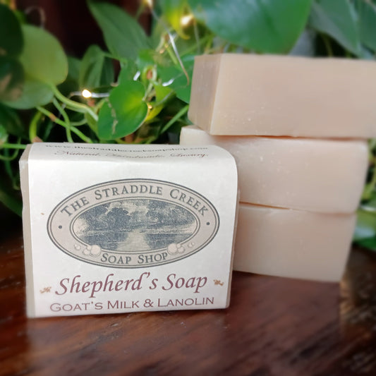 Shepherd's Soap from The Straddle Creek Soap Shop on a wooden surface with plants in the background