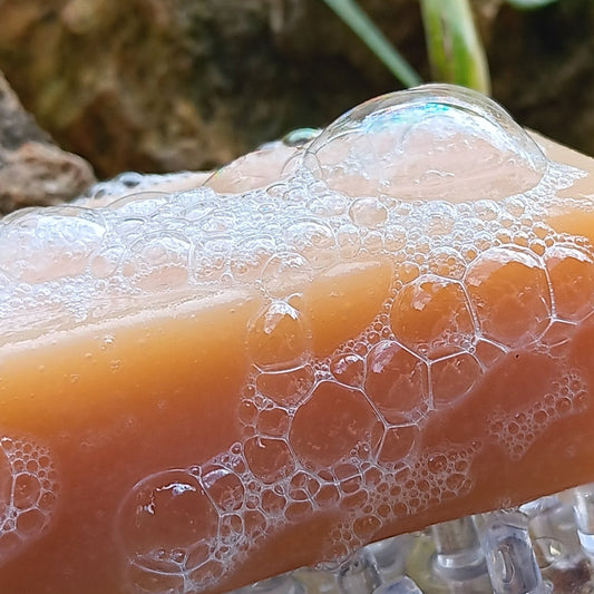 Straddle Creek Soap Shop goat's milk soap on a soap dish with visible lather