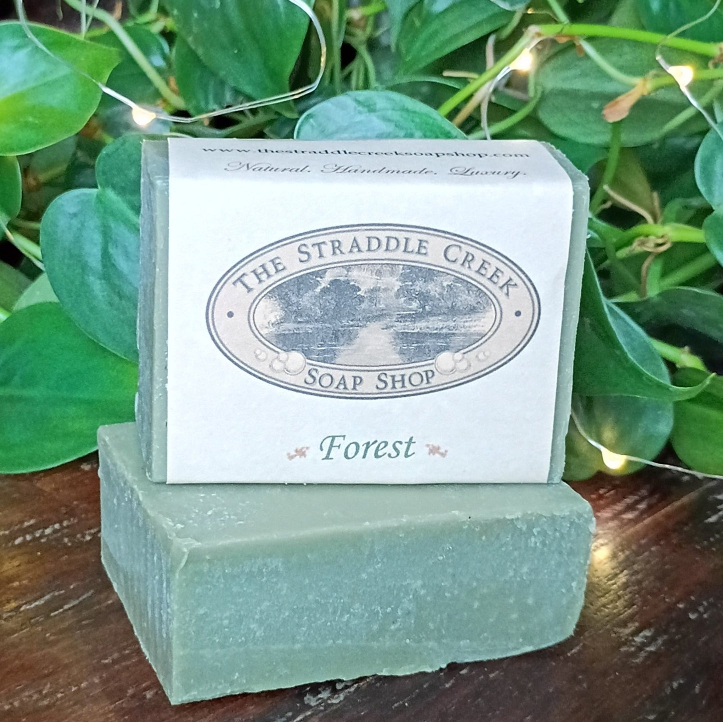 Bar of soap with 'The Straddie Creek Soap Shop' label on a green leafy background